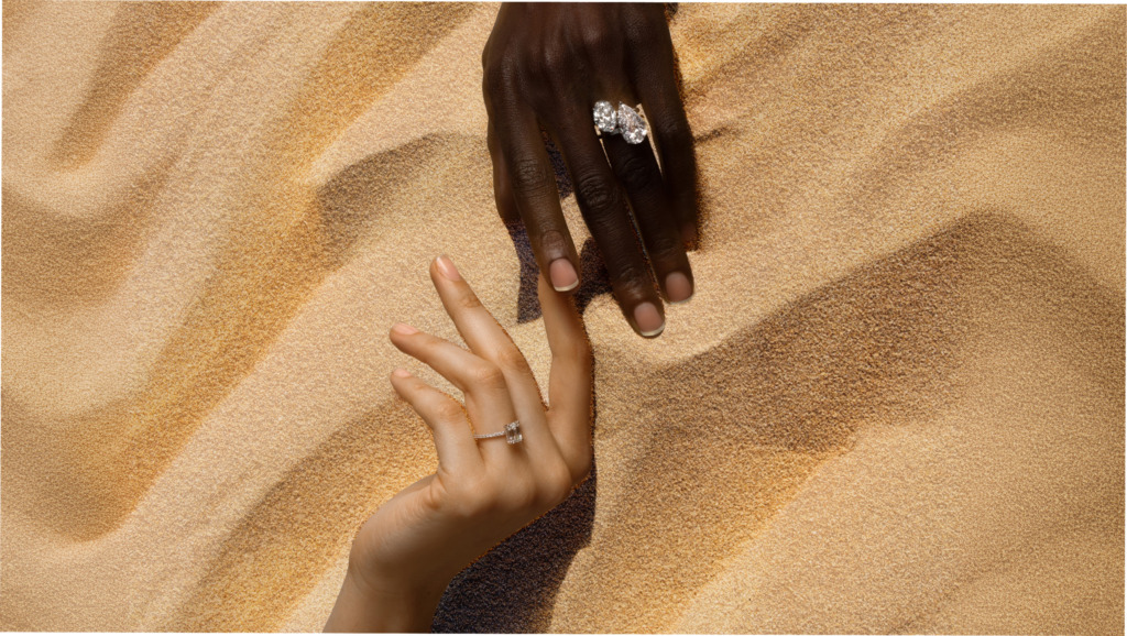 Two hands, each wearing responsibly sourced natural diamond rings